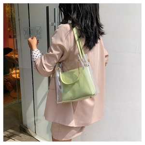 Detailed back view of a clear PVC jelly bag with light green leather inner pouch and strap