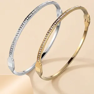 Elegantly stacked gold and silver plated stainless steel bangles with pave-set zircon
