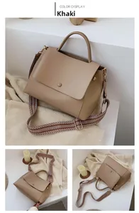 Detail view of khaki PU leather handbag with decorative buckle and woven shoulder strap