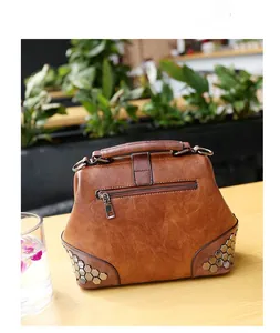 Close-up of retro doctor bag showing rear zipper pocket and metallic rivet details