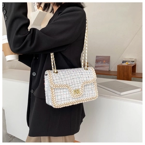 Détail du sac bandoulière en tweed avec chaîne dorée et bordures tissées texturées