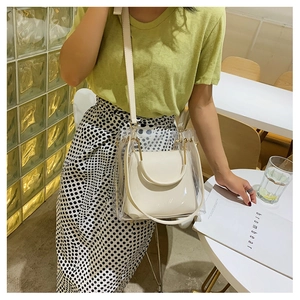 Detailed view of clear PVC jelly tote with white inner pouch shown in use outdoors