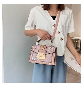 Pink snake pattern handbag with gold rivets, chain accent and adjustable shoulder strap