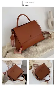 Brown faux leather handbag detail showing woven strap and textured surface