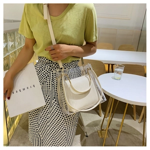 Detail of clear PVC waterproof jelly bag with white leather inner pouch and gold hardware