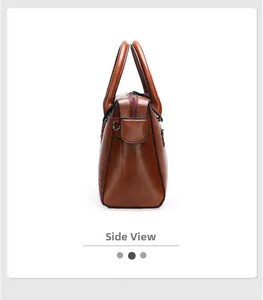 Detailed side view of brown faux crocodile leather tote with metal D-rings and dual handles