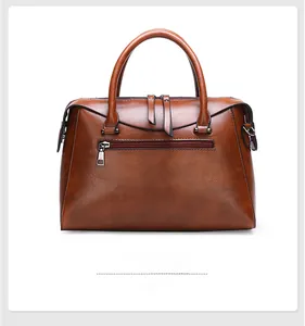 Detailed back view of a dark brown crocodile embossed shoulder bag with zipper pocket