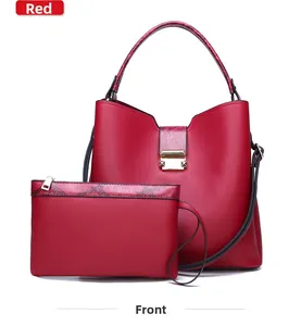 Detail of red bucket bag set featuring snakeskin trim and golden metal lock hardware