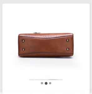 Detailed bottom view of brown faux leather tote with crocodile pattern and silver metal feet
