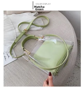 Detail of matcha green transparent jelly bag with gold handles and leather inner pouch