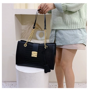 Detailed view of black crocodile pattern leather texture with golden metal buckle