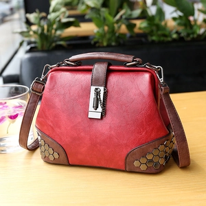 Retro doctor style leather handbag in red and brown with metal rivet accents