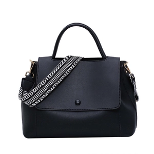 Minimalist black tote bag for women with a patterned wide strap and solid top handle