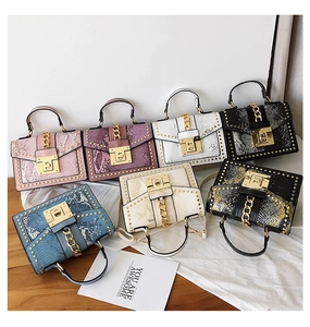 Collection of stylish faux snake skin handbags with metallic studs and chain locks