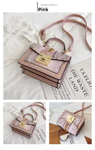 Detail of pink crossbody bag with snakeskin flap and golden rivet embellishments