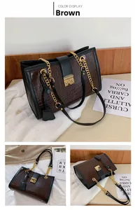 Detail of brown crocodile pattern tote bag featuring gold-tone hardware and chain strap