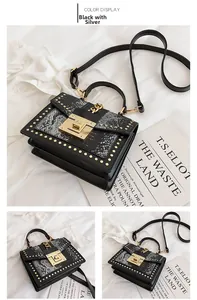 Detail of black crossbody bag with snakeskin texture flap and gold metal hardware