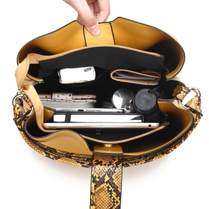 Yellow leather tote bag with snakeskin trim showing spacious interior storage capacity