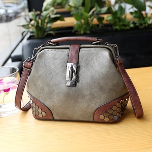 Vintage bluish grey doctor bag with brown handles and bronze rivet details