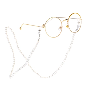 Golden round frame glasses with elegant white pearl decorative strap on white background