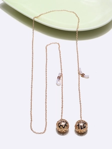Detail of rose gold non-slip eyewear chain featuring hollow ball charms and rubber loops