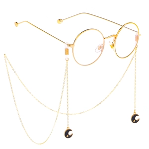 Golden eyewear chain with moon and star pendants on round vintage glasses