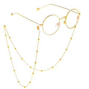 Minimalist gold round frame glasses with a delicate matching beaded eyewear chain