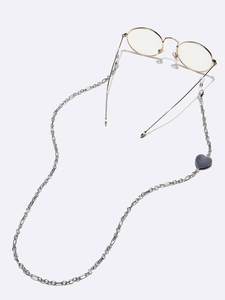 Detailed view of silver metal eyeglass chain with heart stone charm and silicone loops