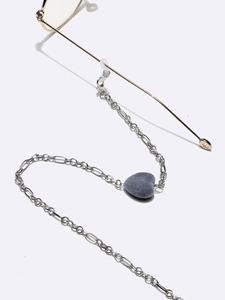 Detail of silver eyewear chain featuring a grey heart-shaped flocking pendant and lobster clasp