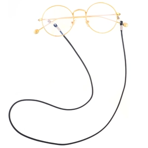 Detail of black woven eyeglass cord with rubber loops attached to gold round frames