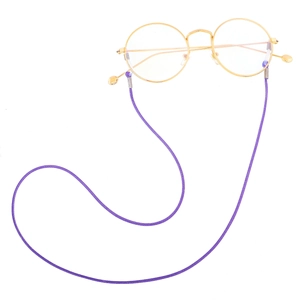 Detail of purple woven eyewear chain with silver metal clasps on gold round glasses
