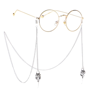 Lunettes rondes dorées avec chaîne en métal argenté et pendentifs en forme de crâne d'oiseau