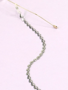 Detail of silver stainless steel eyeglass chain with heart links and rubber grips