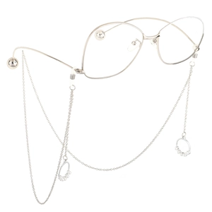 Detail of silver glasses chain with pearl pendant and metal frame in macro view