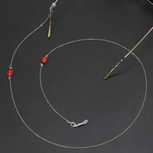 Silver metal glasses chain with red beetle charms and silicone loops on gold frames