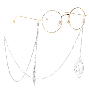 Silver metal eyewear chain with leaf pendant on gold round frame glasses in white background