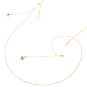 Goldene Brillenkette mit Kreuzanhängern und blauen Augenperlen auf weißem Hintergrund