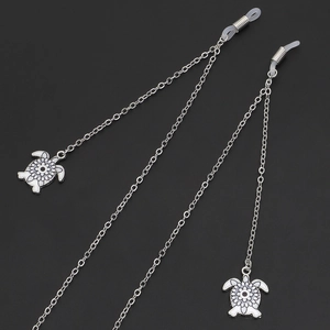 Silver metal eyewear chain featuring white enamel turtle pendants and anti-slip rubber loops