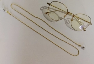 Close-up of golden ball chain eyeglass strap with non-slip silicone loops