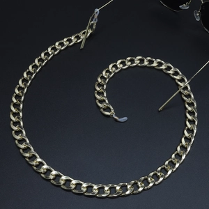 Detail view of a thick golden Cuban link glasses chain with clear silicone loop connectors