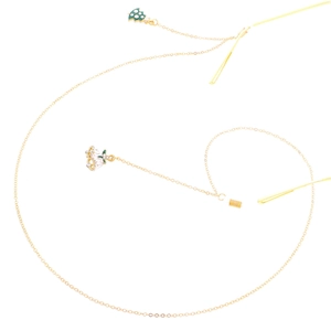 Golden metal glasses chain with green Christmas tree and bell charms on white background