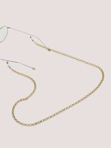 Detail of golden metal glasses chain with adjustable anti-slip rubber loop ends