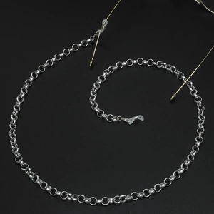 Elegant gold metal eyeglasses chain with non-slip silicone loops on black background