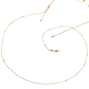 Elegant gold beaded eyewear chain with silicone loops on a clean white background