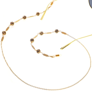 Golden hollow chain eyewear strap with black decorative beads and anti-slip rubber loops