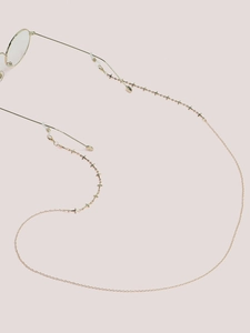 Detail of golden glasses chain with star charms and adjustable silicone loops