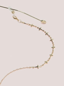 Detail of gold eyewear chain featuring star charms and silicone anti-slip loop connector