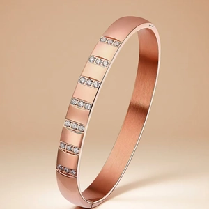 Detailed view of rose gold stainless steel bangle with vertically set cubic zirconia accents