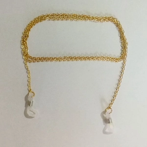 Detail of golden metal eyewear chain with adjustable white silicone non-slip loops