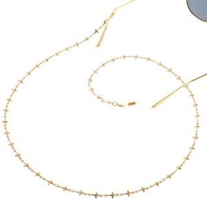 Minimalist gold eyeglass chain with delicate star beads and silicone grips on white backdrop